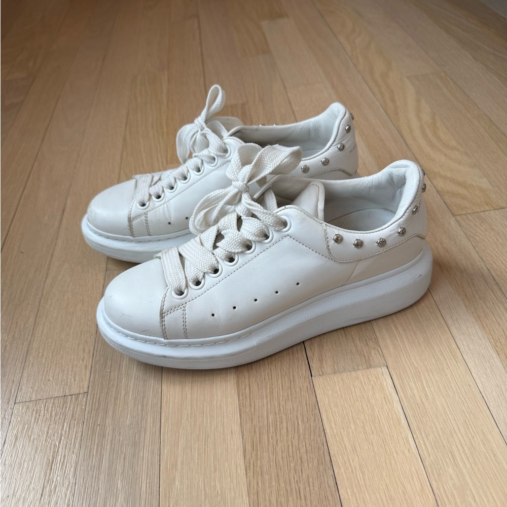 Alexander Mqueen white sneakers with silver studs.